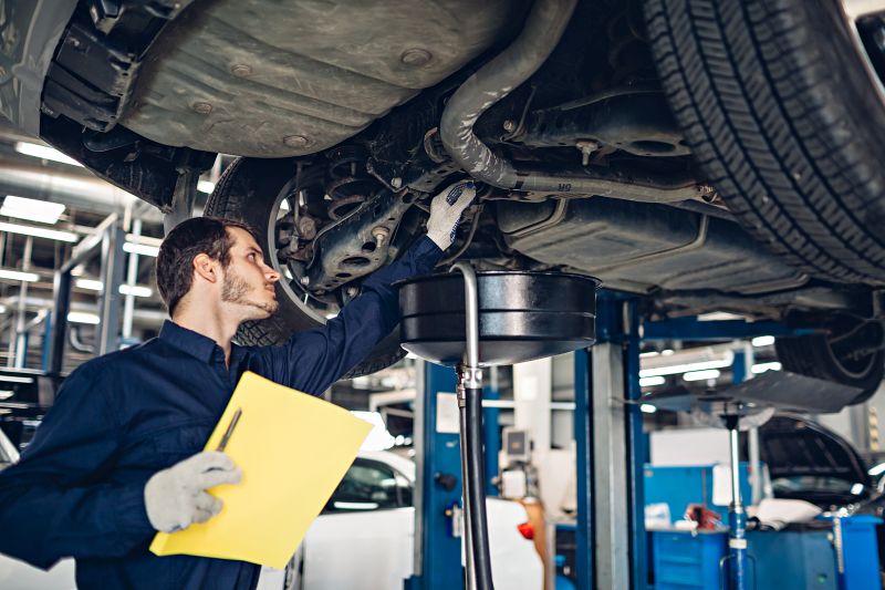 Auto car repair service center. Mechanic examining car